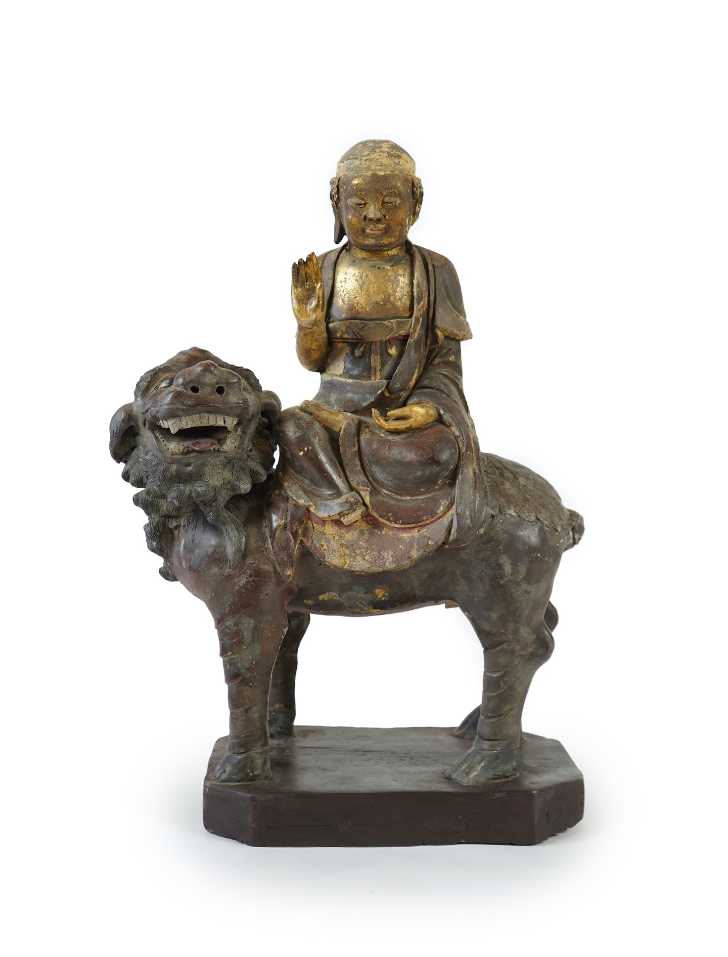A Chinese gilt and polychrome lacquered stucco work and wood figure of Manjushri on a lion, Yuan-Ming dynasty